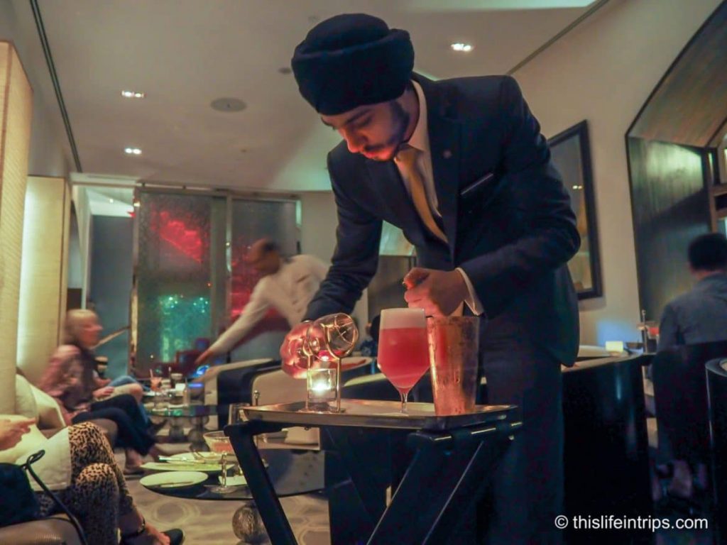 Carefully preparing the brandy glass to be poured into the cocktail mix