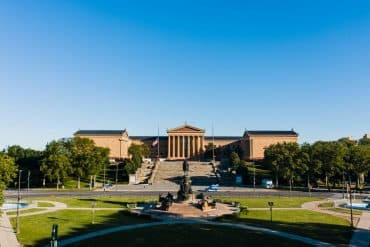 old museum of art near sculptures and lawn in philadelphia