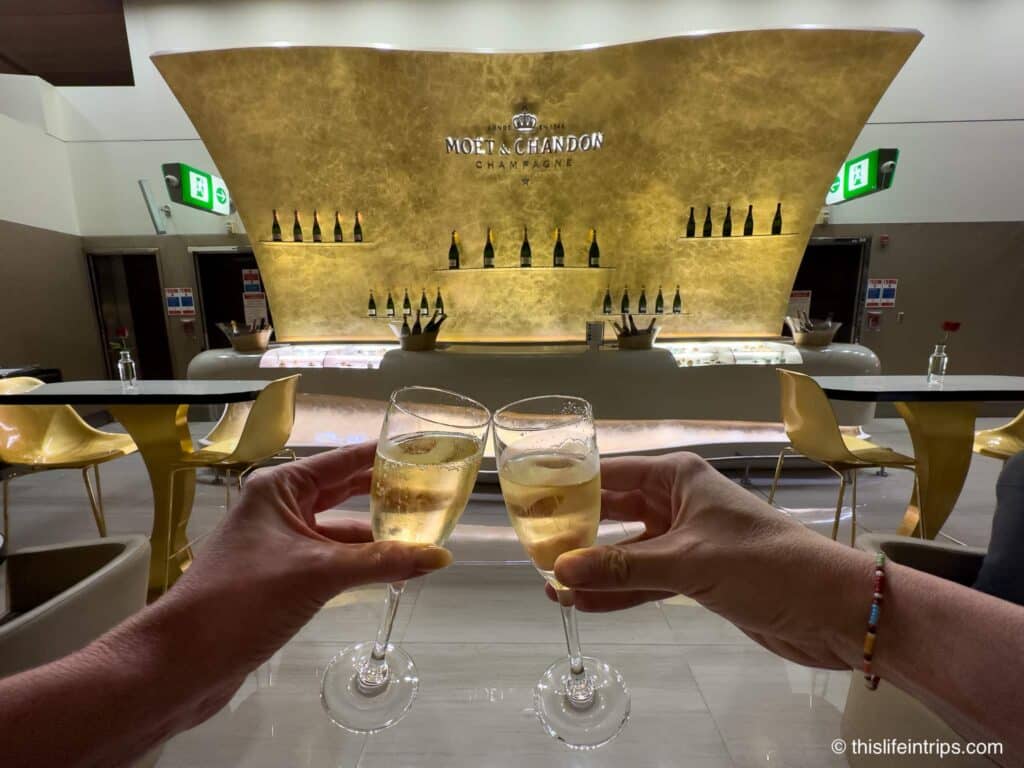 Cheers photo in front of the Moet Champagne bar at the DXB Emirates Business Class Lounge