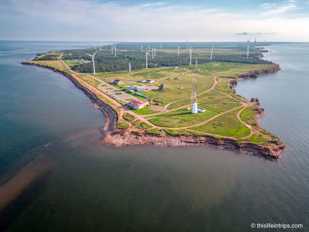 arial shot of North Cape PEI with lighthouse and windmills in the distance.