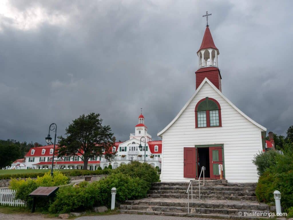 Tadoussac chapel with the Hotel Tadoussac and its red roof in the background