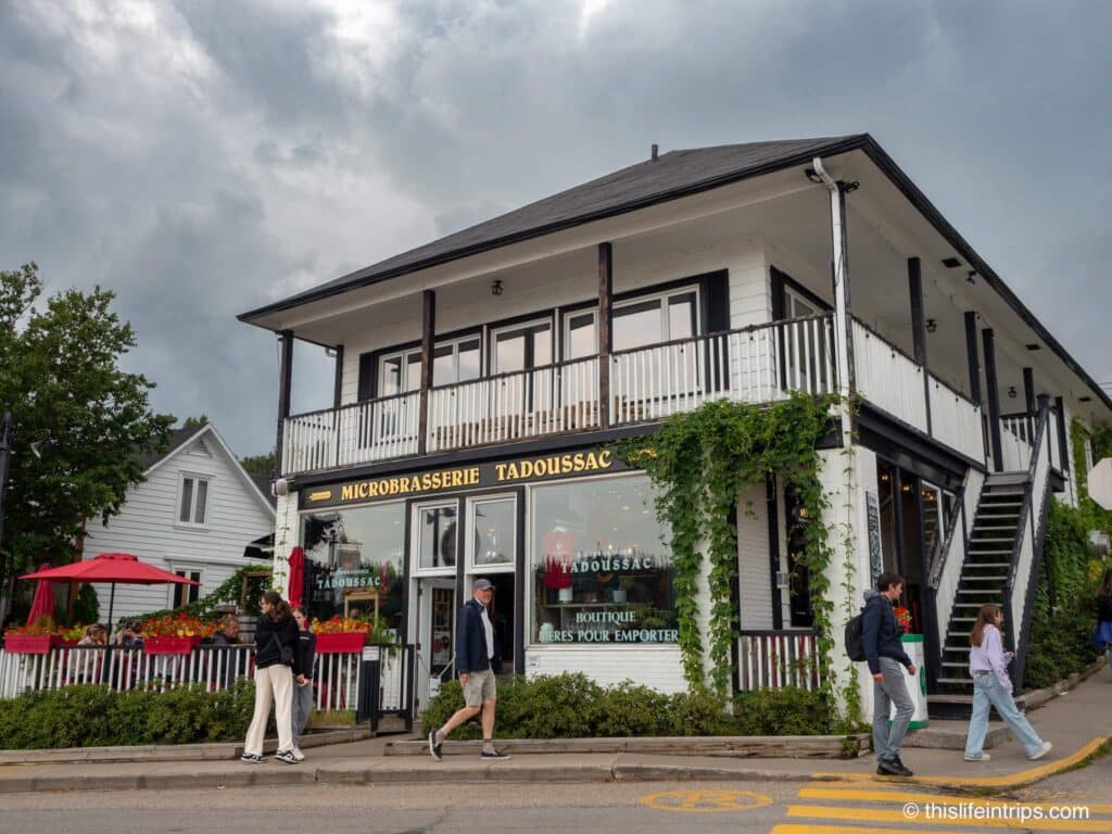 Exterior of Microbrasserie Tadoussac with people walking in front