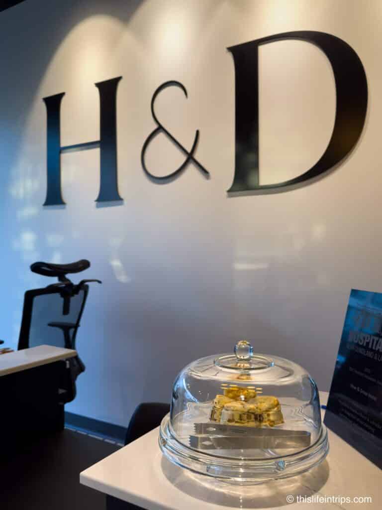 H&D logo with a glass case with biscuits in it at the Hew and Draw Hotel in Corner Brook Newfoundland