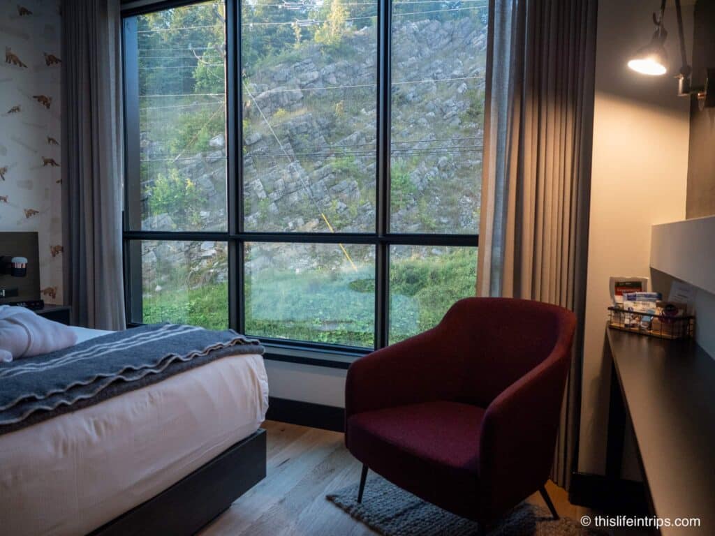 a red chair by the window at the Hew and Draw Hotel in Corner Brook Newfoundland