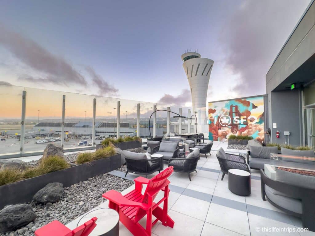 bright red Muskoka chairs on the terrace of the San Francisco Air Canada Lounge