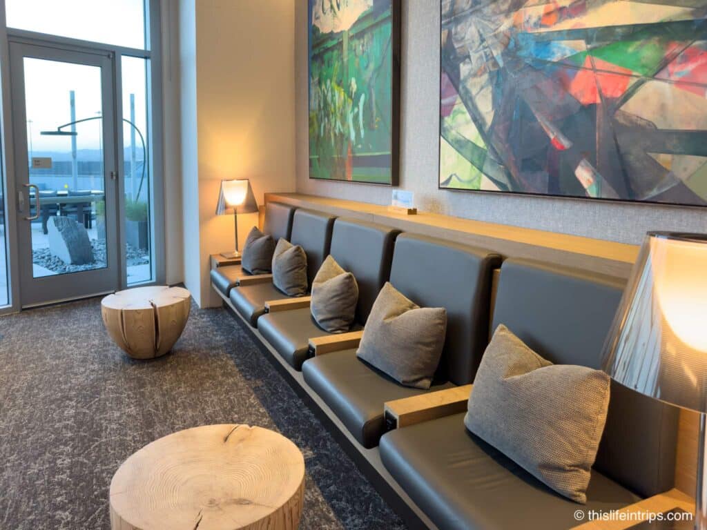 Seating options at the San Francisco Air Canada Lounge with wood stump tables