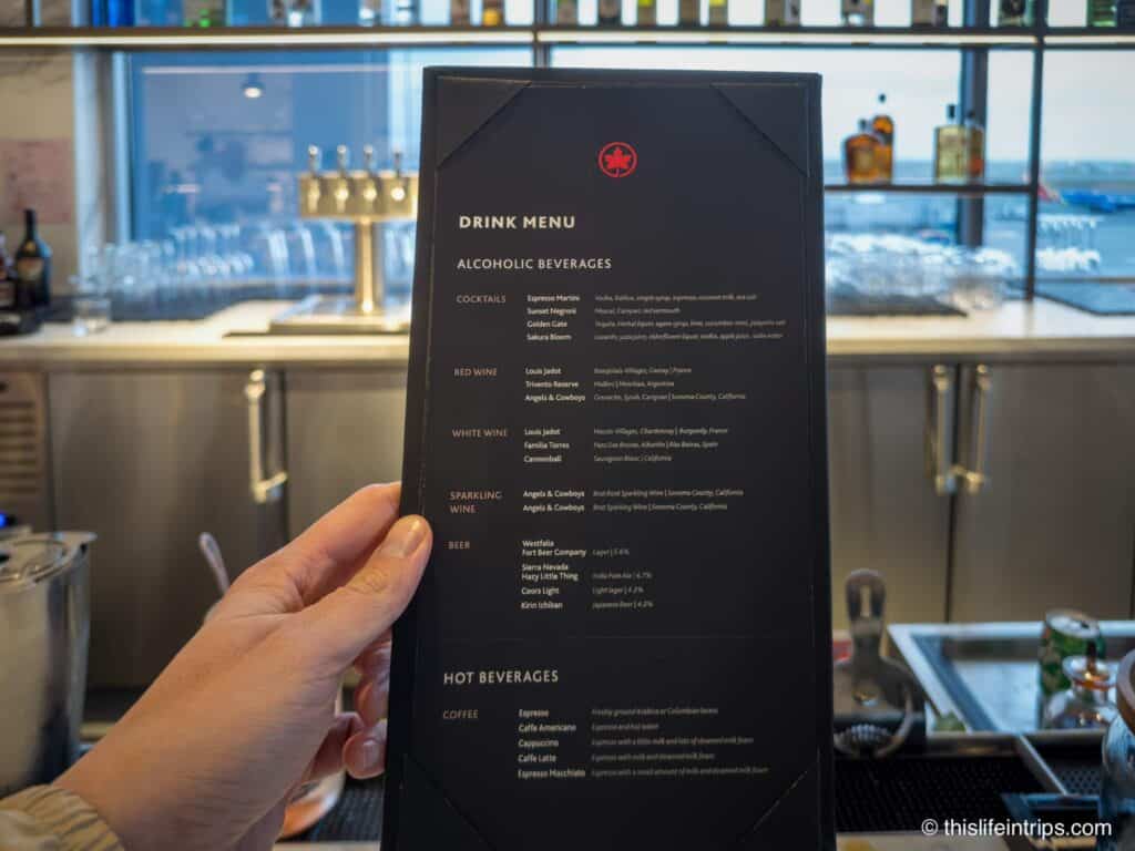 hand holding up Air Canada SFO lounge menu