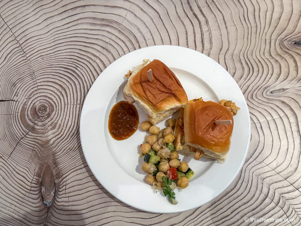 Meal of two buffalo chicken sliders with chickpea salad side at the Air Canada lounge San Francisco