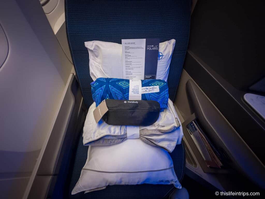 United Polaris business class seat with amenities