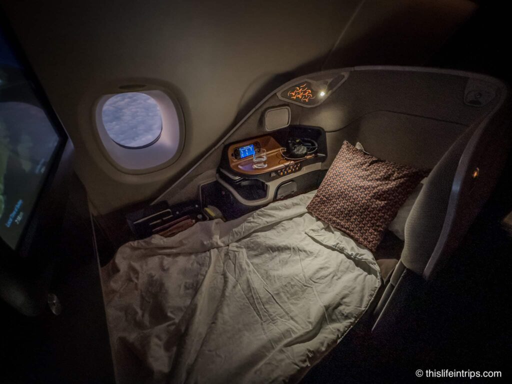 Singapore Airlines a380 Business Class seat laid flat with bedding