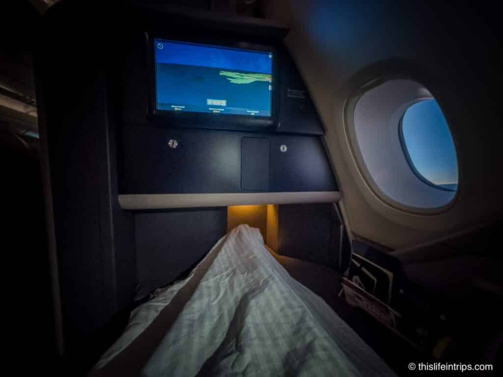 Singapore Airlines a380 Business Class seat laid flat with bedding