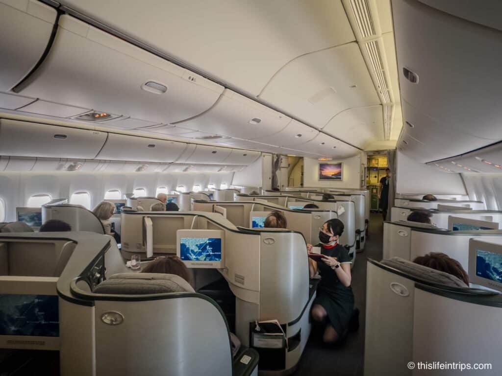 Eva Air Boeing 777 300er business class cabin with hostess taking a meal order