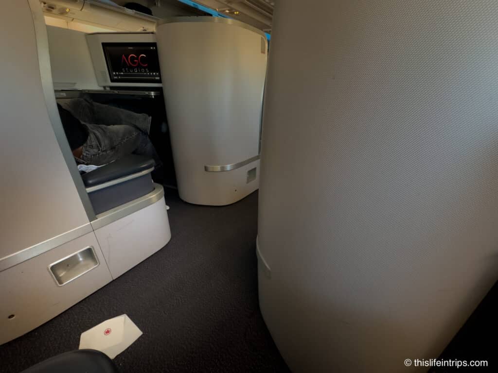 debris in the aisle of an Air Canada A330 business class flight
