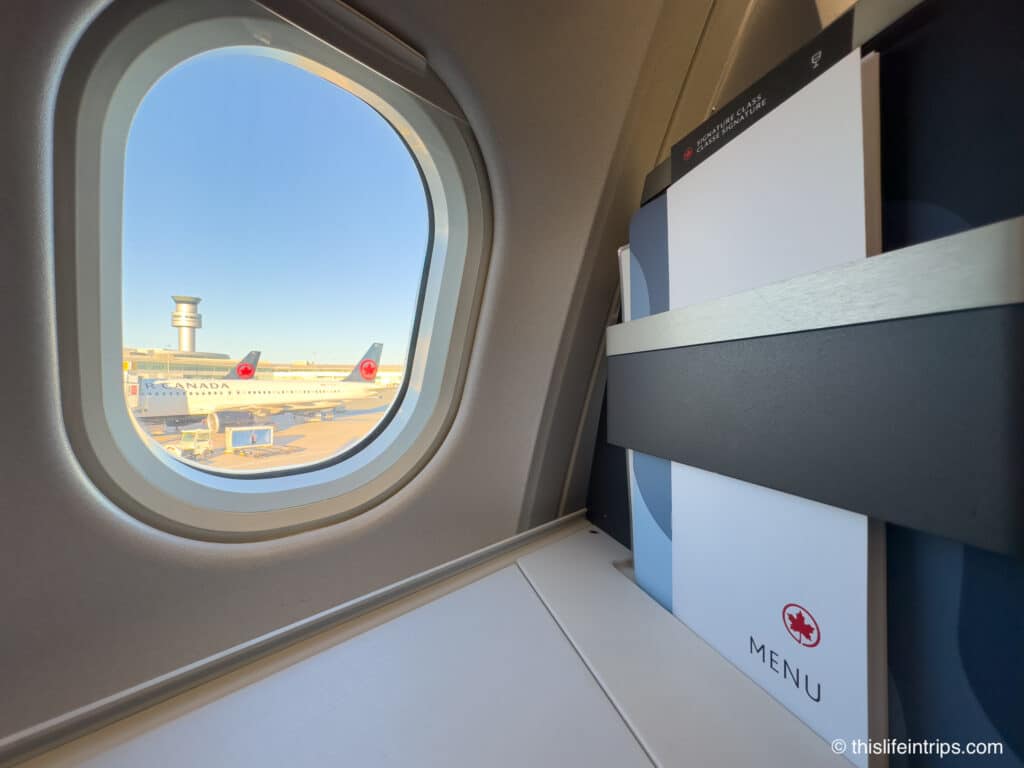 Air Canada A330 business class seat with menu and window