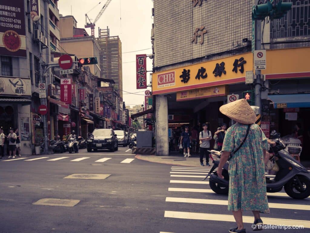 Women crossing street with a rice hat in Taipei
