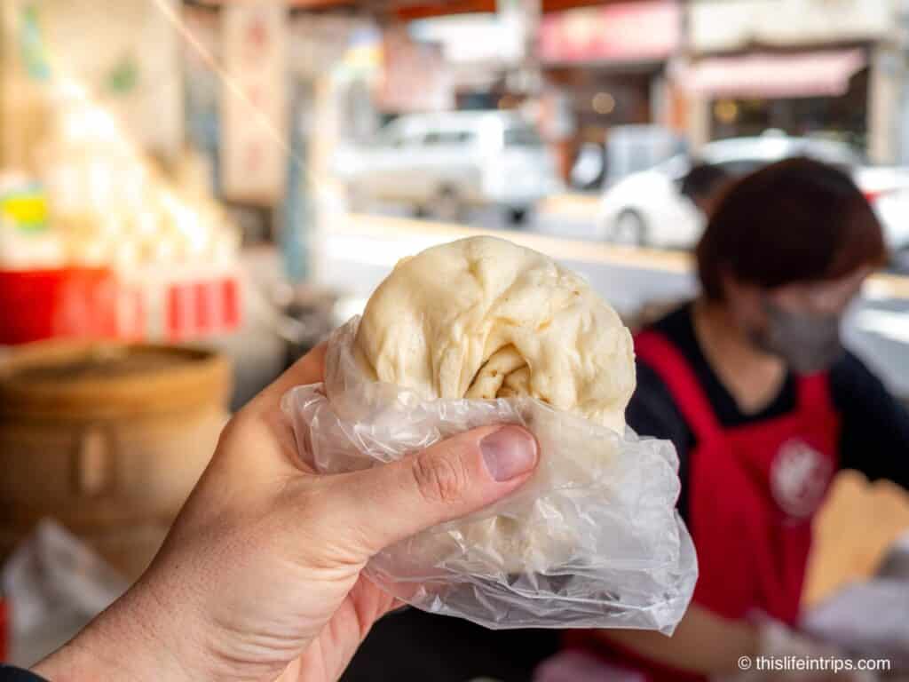 Hand holding up steam bun in Taipei