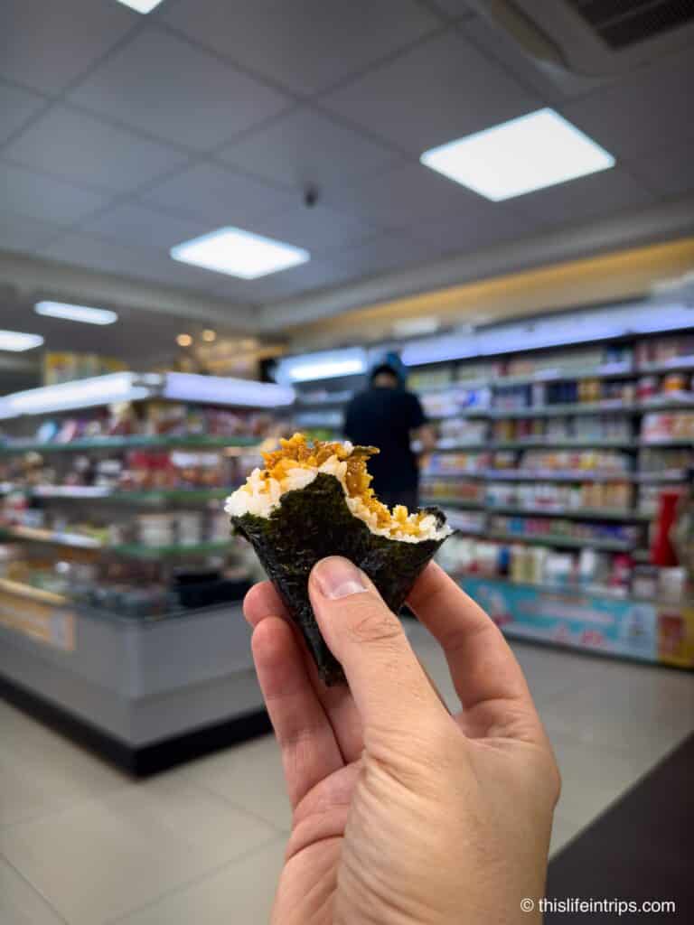 hand holding up Onigiri at a Family Mart in Taipei