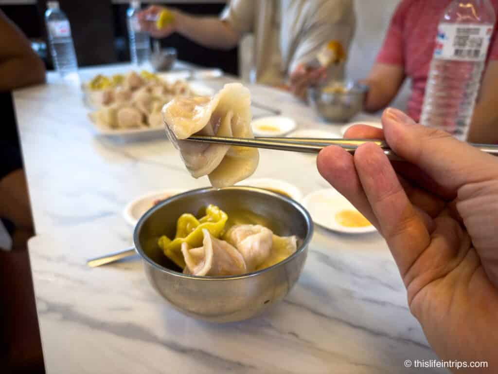 Chopsticks holding up a dumping on a Taipei Bike Tour brunch stop