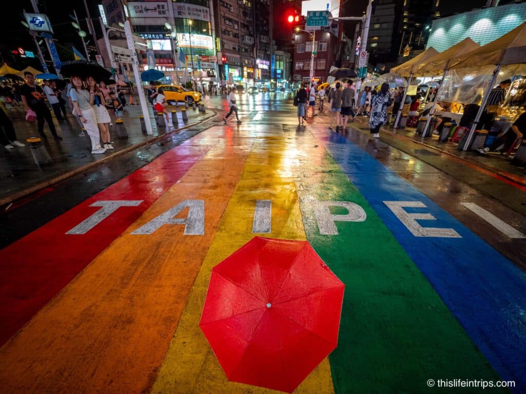 Taipei rainbow crosswalk with red umbrella on it