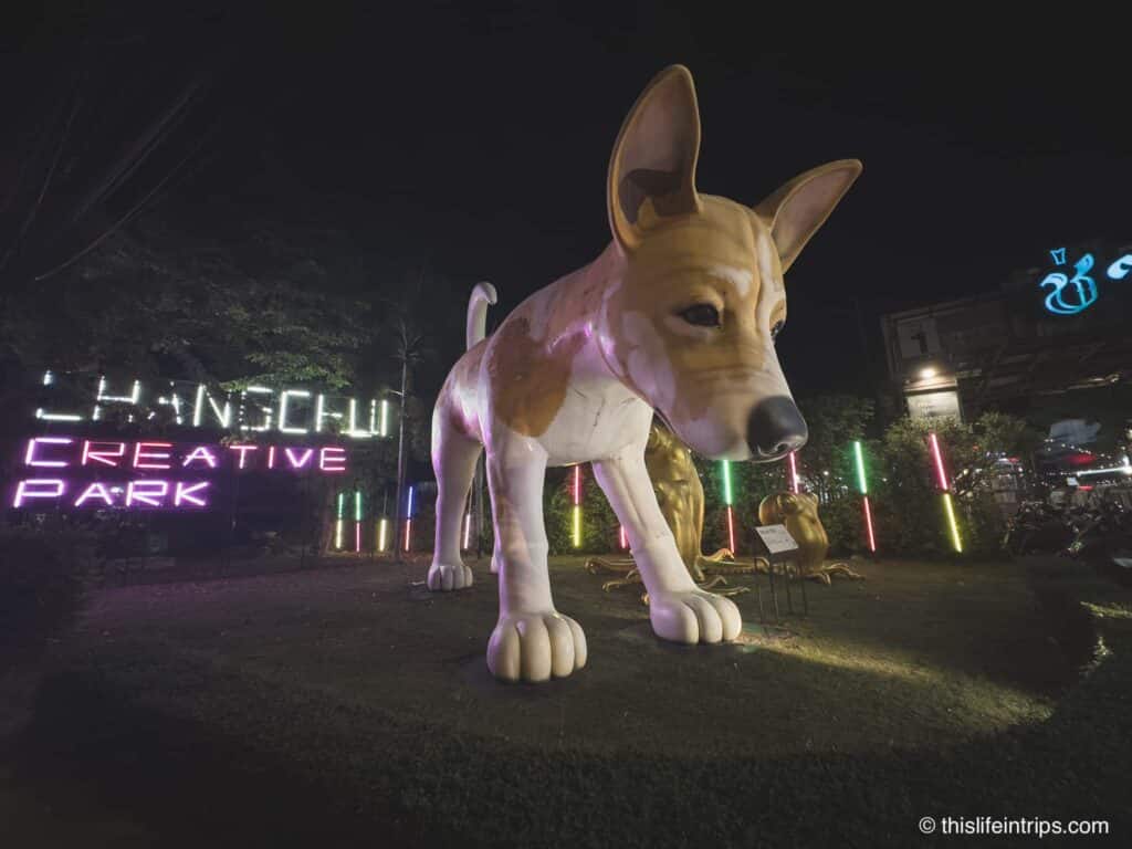 Dog sculpture and neon sign welcoming visitors to changchui creative park