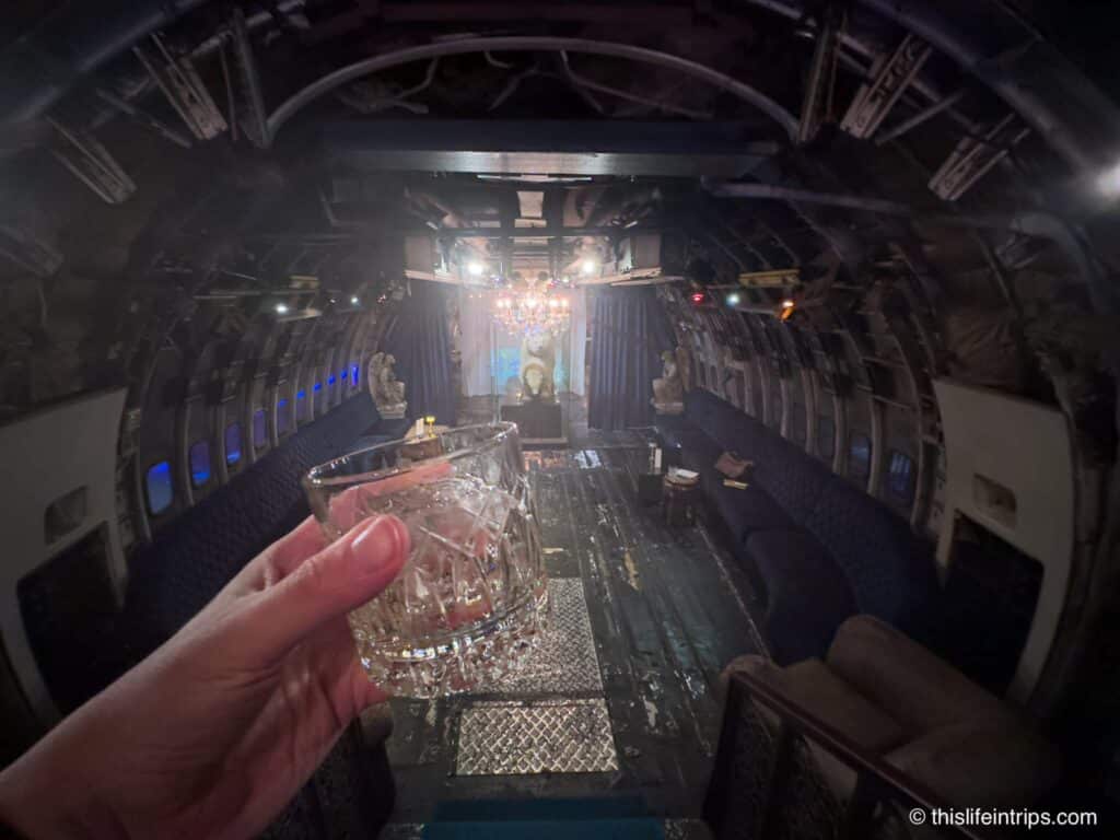 Hand holding up cocktail at Na Oh inside the plane at the center of changchui creative park