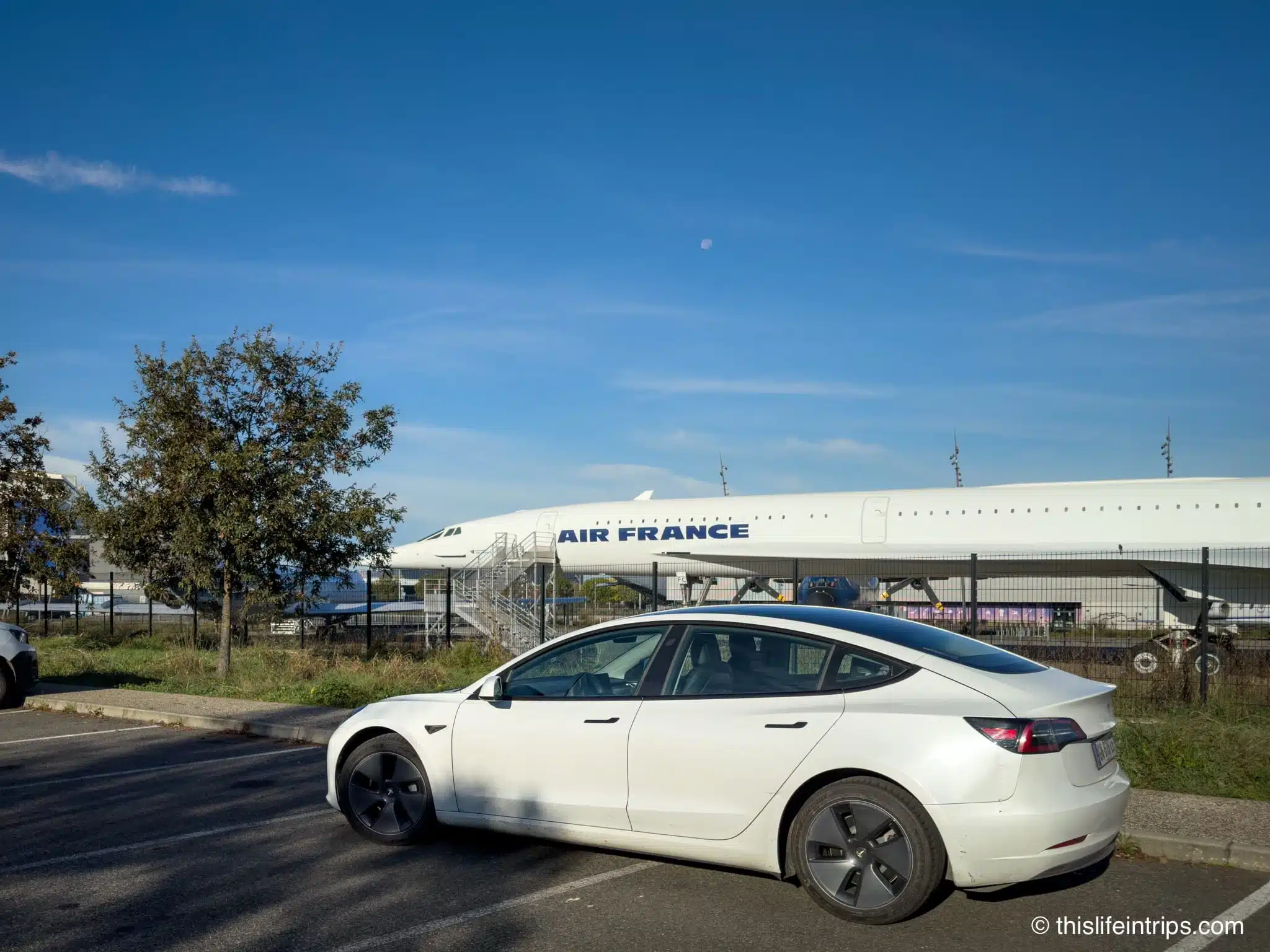 Tesla Model 3 parked next to a Concord at the Airbus museum in Toulouse France