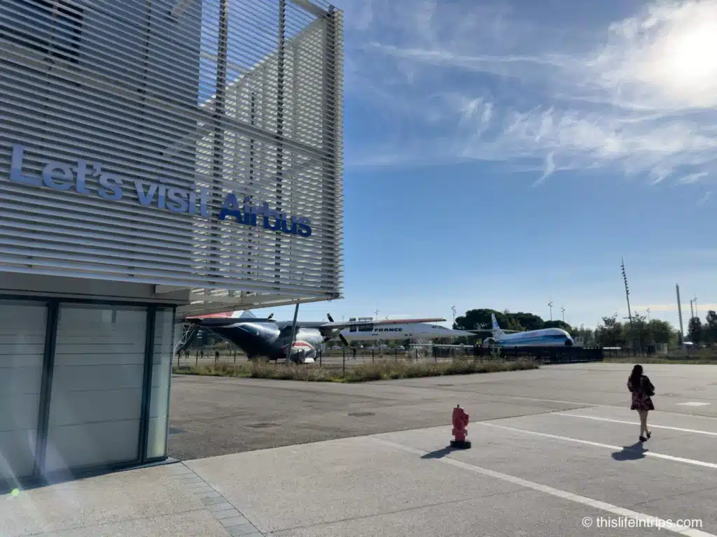 Women walking past a Let’s Visit Airbus sign at the Airbus Museum in Toulouse France