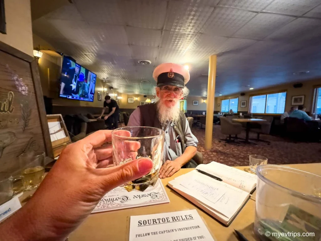 hand holding up sour toe cocktail dawson city