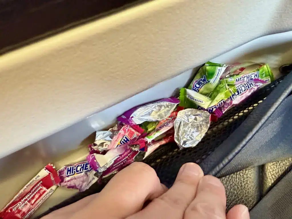 candy wrappers left in seat on a WestJet Premium Economy Review