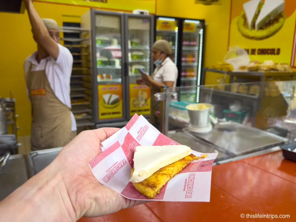 hand holding up a Chócolo on a Medellin street food tour